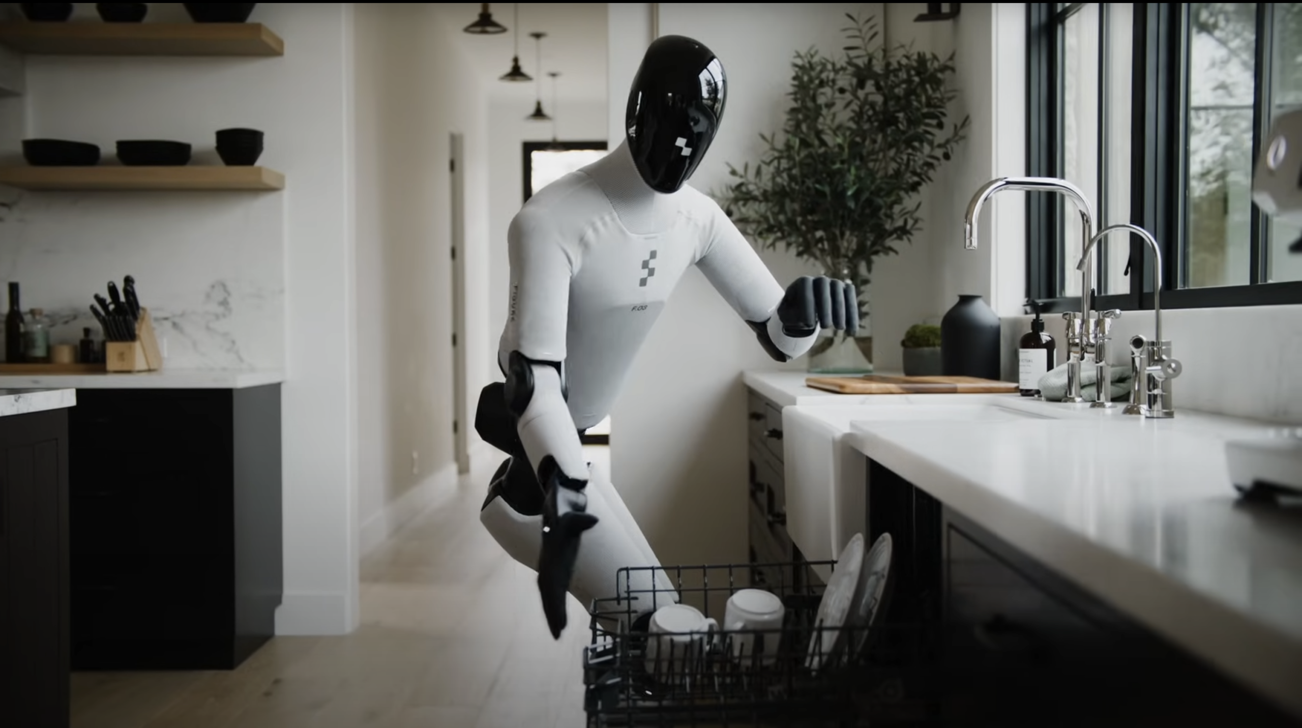 Robotul humanoid Figure 03 încărcând mașina de spălat vase într-o bucătărie modernă